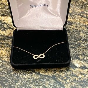 Andrew Minton Jewelers 14k gold diamond infinity necklace.